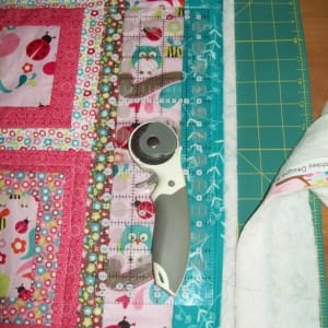 Step 6: the quilt edges are trimmed after machine quilting and before binding.